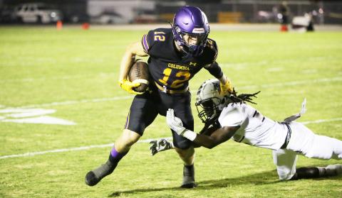 Columbia receiver Camdon Frier tries to evade a tackle by a Madison County defender on Friday. (BRENT KUYKENDALL/Lake City Reporter)