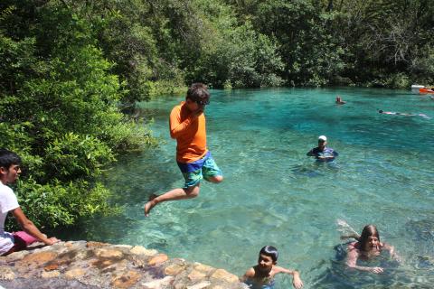 Dariel Garcia, 10, leaps into water at Ichetucknee Springs State Park on Monday afternoon. Thousands of people visited the park during the holiday weekend. (TONY BRITT/Lake City Reporter)