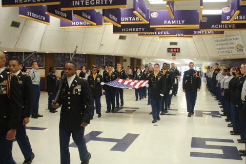 Cadets with the Columbia High School JROTC march the American flag through the school’s commons area Monday morning in a ceremony honoring the victims of the Sept. 11, 2001, terrorist attacks. (TONY BRITT/Lake City Reporter)