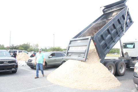 An additional load of sand is dumped at the Southside Sports Complex on Tuesday morning as residents bagged sandbags in preparation for Hurricane Ian. (TONY BRITT/Lake City Reporter)
