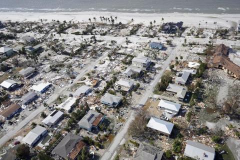 This aerial photo shows damaged homes and debris in the aftermath of Hurricane Ian on Thursday in Fort Myers. (WILFREDO LEE/Associated Press)