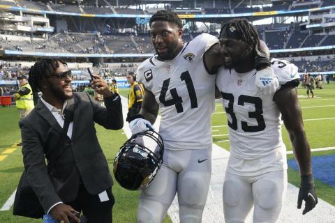 Jacksonville Jaguars linebacker Josh Allen (41) and linebacker Devin Lloyd (33) walk off the field after Sunday's win over the Los Angeles Chargers in Inglewood, Calif. (MARCIO JOSE SANCHEZ/Associated Press)