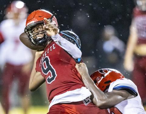 Lafayette quarterback Tywan Williamson avoids a sack by throwing the ball away against Hamilton County on Friday. (JACK HOWDESHELL/Special to the Reporter)