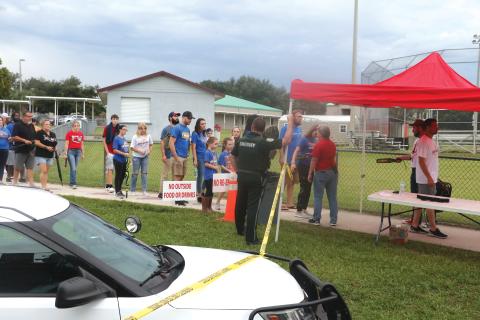 Visitors at last Friday’s Fort White-Newberry football game are searched for weapons and any other hazardous materials on their way into Arrowhead Stadium at Fort White High School. (MORGAN MCMULLEN/Lake City Reporter)