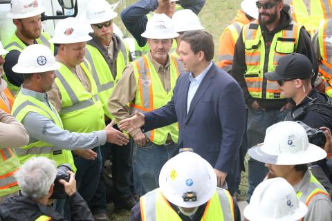 Gov. Ron DeSantis shakes hands with linemen at the Florida Power & Light processing site at the Florida Gateway Fairgrounds on Wednesday morning following a press conference to address Hurricane Ian. (MORGAN MCMULLEN/Lake City Reporter)