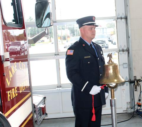 A Lake City firefighter rings a bell commemorating the times that planes struck the Twin Towers and Pentagon on Sept. 11, 2001, during last year’s Patriot Day ceremony. (FILE)