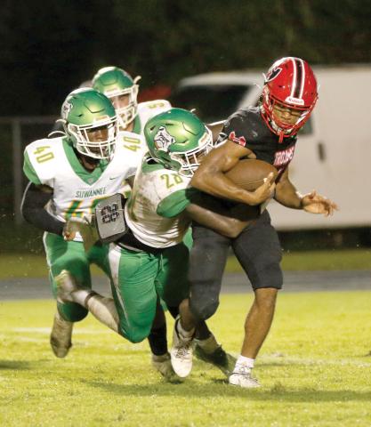 Suwannee defensive lineman Robert Robinson wraps up Hamilton County quarterback Chance Cherry last Friday. (JAMIE WACHTER/Lake City Reporter)