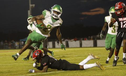 Suwannee’s Jay Smith leaps over a Hamilton County player on a punt return Friday night at Veterans Memorial Stadium. (JAMIE WACHTER/Lake City Reporter)