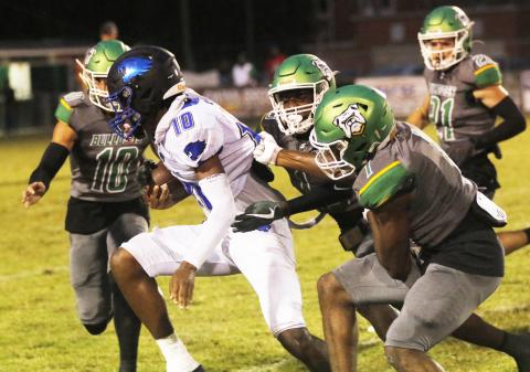 Suwannee cornerbacks PJ Davis (13) and Radarian Griffin (1) tackle Wildwood receiver Jamari Dickens last Friday. (JAMIE WACHTER/Lake City Reporter)