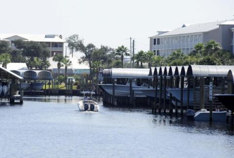 A boat cruises through a marina in rebuilt Mexico Beach on Oct. 11. Destroyed by Hurricane Michael, the Florida Panhandle community is still rebuilding four years later. (JAY REEVES/Associated Press)
