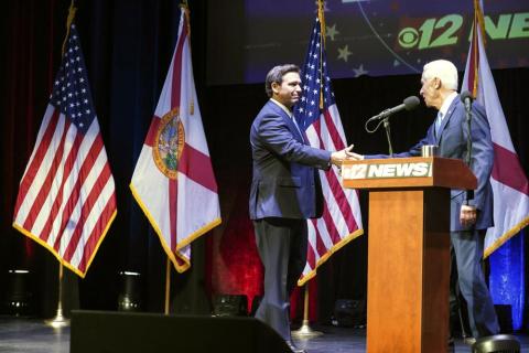 Florida’s Republican Gov. Ron DeSantis (left) and Democratic opponent Charlie Crist take to the stage for their only scheduled debate in Fort Pierce Monday. (CRYSTAL VANDER WEIT/TCPalm.com via AP)