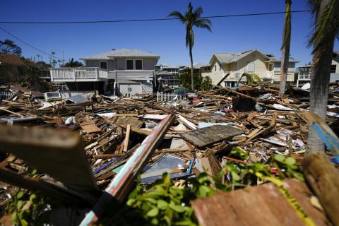 A road is completely filled with a tall pile of debris from destroyed beachfront homes and businesses, two days after the passage of Hurricane Ian, in Fort Myers Beach on Friday. (REBECCA BLACKWELL/Associated Press)