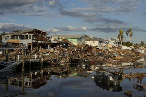 Cars and debris from washed away homes line a canal in Fort Myers Beach on Wednesday, one week after the passage of Hurricane Ian. Hurricane Ian confounded one key computer forecast model, creating challenges for forecasters and Florida residents. (REBECCA BLACKWELL/Associated Press)