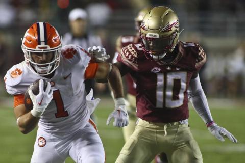 Clemson receiver Joseph Ngata runs after a catch as Florida State defensive back Jammie Robinson tries to grab him during Saturday’s game in Tallahassee. (PHIL SEARS/Associated Press)