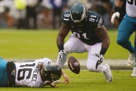 Jacksonville Jaguars quarterback Trevor Lawrence fumbles the ball and Philadelphia Eagles defensive lineman Fletcher Cox recovers it during Sunday’s game in Philadelphia. (CHRIS SZAGOLA/Associated Press)