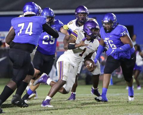 Columbia quarterback Tyler Jefferson scrambles for yardage as Trinity Christian defensive lineman Nick Williams gives chase on Sept. 23. (BRENT KUYKENDALL/Lake City Reporter)