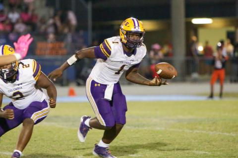 Columbia quarterback Tyler Jefferson flips the ball to a teammate during Friday’s game against Orange Park. (BRENT KUYKENDALL/Lake City Reporter)