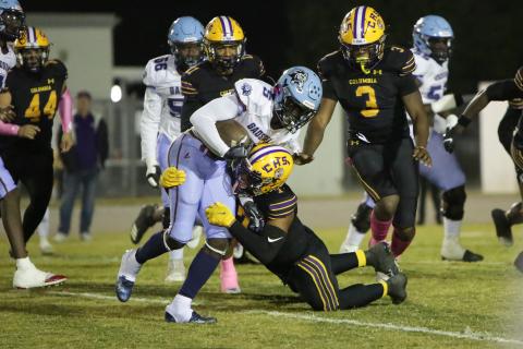 Columbia safety Amare Ferrell wraps up Gadsden County running back Cedric Byrd on Friday night. (BRENT KUYKENDALL/Lake City Reporter)