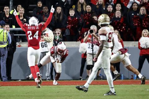 N.C. State defensive back Devan Boykin (12) intercepts a pass intended for Florida State's Mycah Pittman as N.C. State cornerback Derrek Pitts Jr. (24) celebrates during Saturday's game in Raleigh, N.C. (KARL B DEBLAKER/Associated Press)