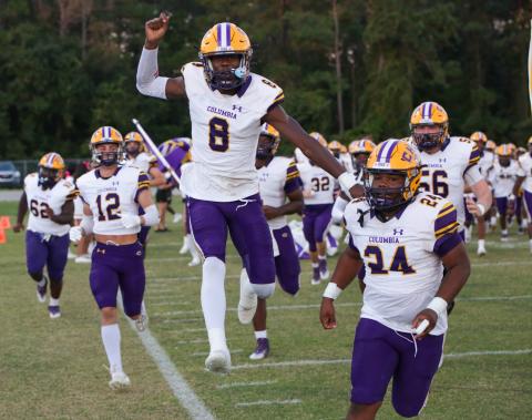 Columbia receiver Jaylen Cooper (8) leaps into the air alongside linebacker Wilson Philemon (24) as they lead their team onto the field prior to last Friday’s game against Orange Park. (BRENT KUYKENDALL/Lake City Reporter)