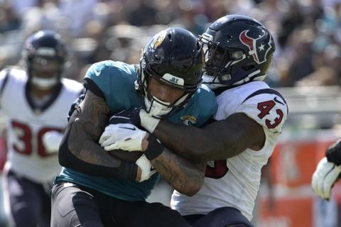 Jacksonville Jaguars tight end Evan Engram is tackled by Houston Texans linebacker Neville Hewitt on Oct. 9 in Jacksonville. (PHELAN M. EBENHACK/Associated Press)