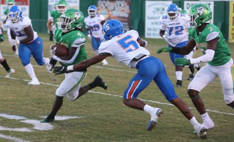 Suwannee running back Marquavious Owens runs past Taylor County safety Da’Varin Mccoy on Monday. (PAUL BUCHANAN/Special to the Reporter)