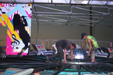 Andrew Mielke sets up panels for the Music Fest ride on Wednesday evening at the Florida Gateway Fairgrounds. The 68th annual Florida Gateway Fair begins Friday afternoon. (TONY BRITT/Lake City Reporter)