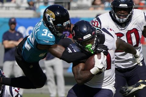 Jaguars cornerback Tyson Campbell tackles Houston Texans running back Dameon Pierce during Sunday's game in Jacksonville. (JOHN RAOUX/Associated Press)