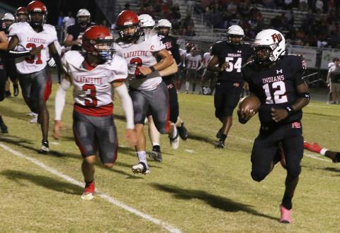 Fort White running back Najeeb Smith eyes Lafayette safety Baylor Johnson on a run Friday night at Arrowhead Stadium. (MORGAN MCMULLEN/Lake City Reporter)