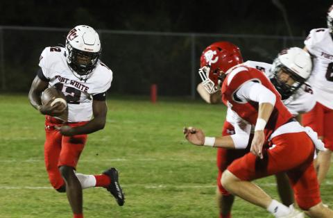Fort White running back Najeeb Smith rushes up the field against Dixie County on Friday. (MORGAN MCMULLEN/Lake City Reporter)