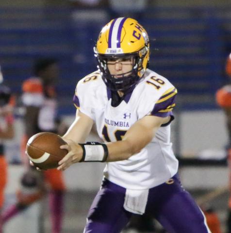 Columbia quarterback Evan Umstead turns to hand the ball off during Friday’s game against Orange Park. (BRENT KUYKENDALL/Lake City Reporter)