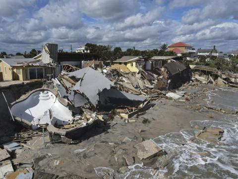 Homes are damaged and collapsed after the shore on which they stood was swept away following the passage of Hurricane Nicole Thursday in Wilbur-By-The-Sea. (REBECCA BLACKWELL/Associated Press)