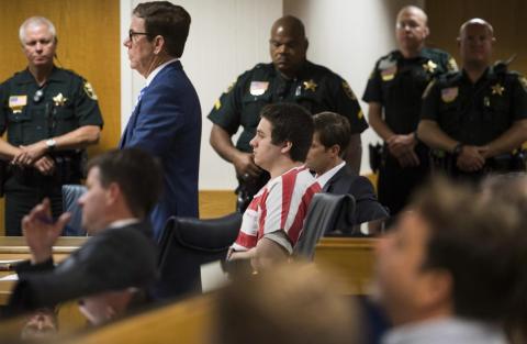 Austin Harrouff, center, wearing stripes, accused of brutally killing a Tequesta couple in 2016, appears Aug. 2, 2019, at the Martin County Courthouse in Stuart. (AP File)