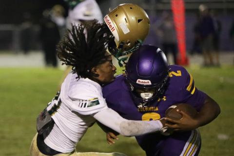 Columbia running back Tony Fulton plows through a Lincoln defender during Friday’s Region 1-3S quarterfinal at Tiger Stadium. (BRENT KUYKENDALL/Lake City Reporter)