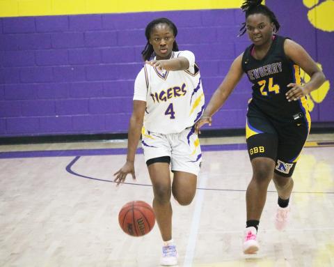 Columbia guard Eriel Baker calls out a play as she dribbles up the court defended by Newberry forward Desia Bryant on Thursday night. (JORDAN KROEGER/Lake City Reporter)