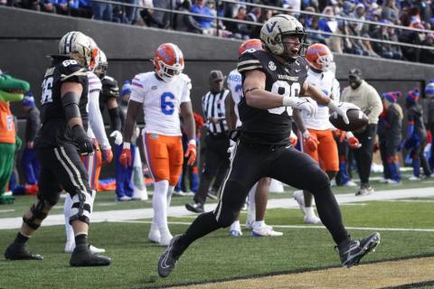 Vanderbilt running back Ray Davis (2) is driven out of bounds by Florida safety Trey Dean III (0) on Saturday in Nashville, Tenn. (MARK HUMPHREY/Associated Press)