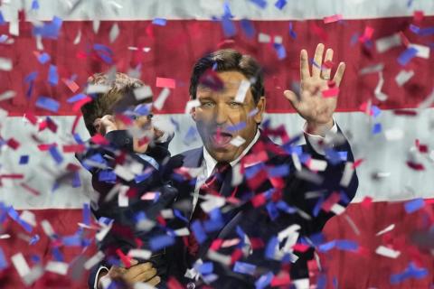 Incumbent Florida Republican Gov. Ron DeSantis holds his son Mason as he celebrates winning reelection, at an election night party Tuesday in Tampa. (REBECCA BLACKWELL/Associated Press)