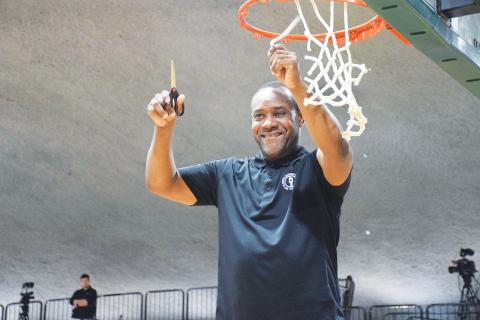 FGC head coach Charles Ruise cuts down a piece of the net after the Timberwolves defeated Pasco-Hernando State College to win the Region 8 championship on Feb. 26 at the Howard Center. (COURTESY)
