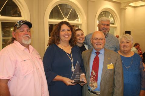 Terri Phillips, (second from left) stands with her husband Bobby Phillips (front row from from left) Jimmy Sparks and Darlene Smith and (back row, from left) Bree Faulkner and James Smith after she was selected as the 2022 Lake City-Columbia County Chamber of Commerce Outstanding Citizen of the Year during the organization’s annual Business Excellence Awards Ceremony on Monday night. (TONY BRITT/Lake City Reporter)