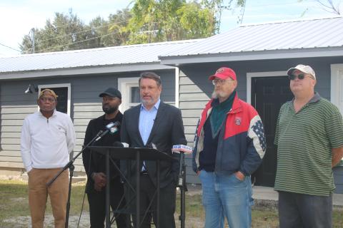 James Hodges (second from right) listens as his attorney John M. Phillips speaks at Thursday’s press conference. (TONY BRITT/Lake City Reporter)