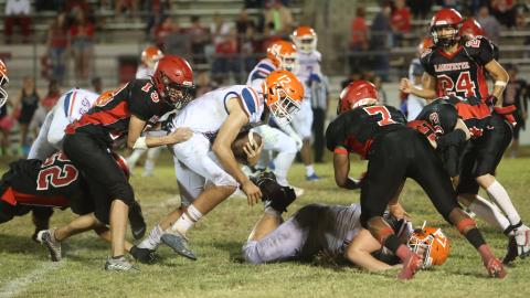 Branford quarterback Thomas Sikes tries to escape a pair of Lafayette tacklers on Oct. 17. (PAUL BUCHANAN/Special to the Reporter)