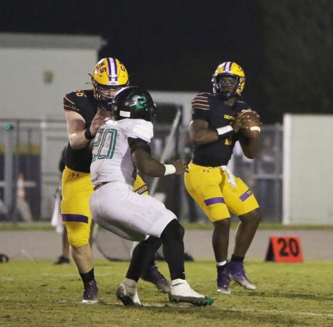 Columbia quarterback Tyler Jefferson (1) drops back to pass while offensive lineman Travis Matthews (56) blocks a Choctaw defender during Friday’s Region 1-3S final. (BRENT KUYKENDALL/Lake City Reporter)
