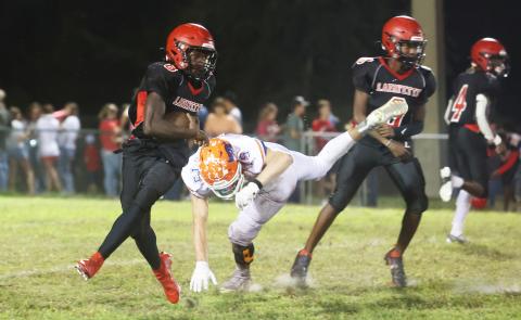 Lafayette running back Johntavious Cook runs past Branford defensive lineman Cole Certain on Oct. 17. (PAUL BUCHANAN/Special to the Reporter)
