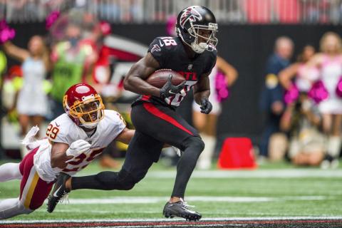 Atlanta Falcons wide receiver Calvin Ridley runs up the field with the ball as Washington cornerback Kendall Fuller dives for a tackle on Oct. 3, 2021, in Atlanta. (DANNY KARNIK/Associated Press)