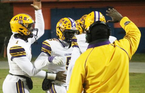 Columbia linebacker Jaden Robinson (5) celebrates with quarterback Tyler Jefferson (1) and others after scoring on a pick-6 against Escambia in the Region 1-3S semifinals on Friday. (JORDAN KROEGER/Lake City Reporter)
