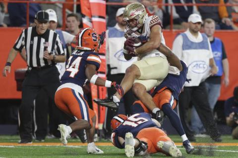 Syracuse defensive back Alijah Clark, defensive back Jeremiah Wilson (24), and linebacker Derek McDonald (15) tackle Florida State wide receiver Mycah Pittman during Saturday's game in Syracuse, N.Y. (JOSHUA BESSEX/Associated Press)