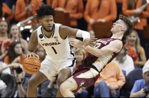 Virginia's Jayden Gardner commits a foul against Florida State’s Tom House during Saturday’s game in Charlottesville, Va. (MIKE KROPF/Associated Press)