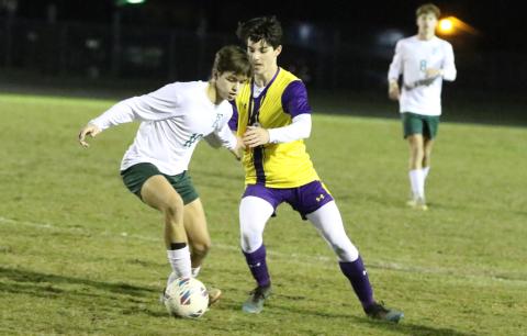 Columbia midfielder Bergen Cobb tries to steal the ball from Fleming Island’s Daniel Vizcarrondo on Wednesday night. (MORGAN MCMULLEN/Lake City Reporter)