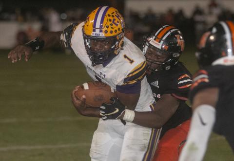 Columbia quarterback Tyler Jefferson tries to pull away from a Lake Wales defender Friday night in a Class 3S state semifinal at Legion Field. (MICHAEL WILSON/Special to the Reporter)