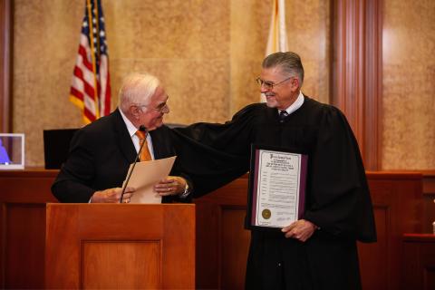 Lake City Mayor Stephen Witt (left) presents retired Third Judicial Circuit Judge Paul S. Bryan with a proclamation honoring Bryan for his three decades of service. (ESTA EBERHARDT/Special to the Reporter)